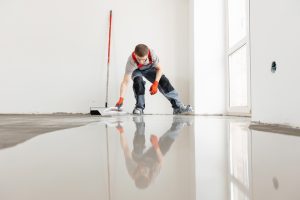 Master,Work,Renovation,Home,With,Sunlight.,Screed,Concrete,With,Self